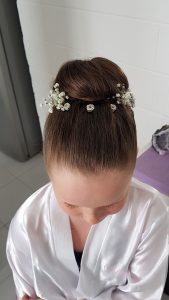 Flower girl with high bun. Doranna Wedding Hairstylist & Bridal Makeup Artist in Playa del Carmen, Mexico
