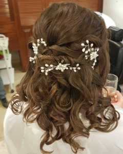 Soft curls half updo by Doranna Wedding Hairstylist & Bridal Makeup Artist at Reef Playacar, Mexico